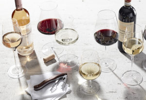 an assortment of wine enthusiast varietal glassware on a white background